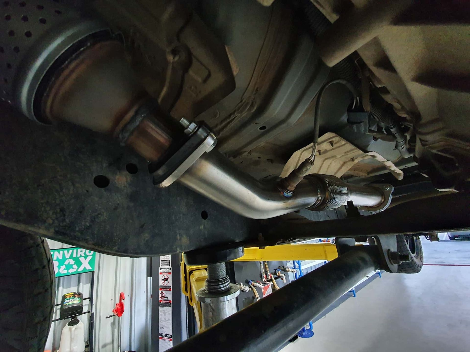 The Underside of a Car With a Exhaust Pipe Attached to It — OSP Automotive & Marine In Grafton, NSW