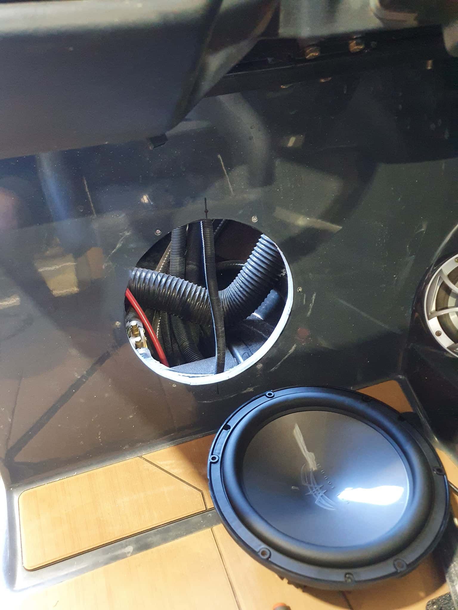 A Subwoofer is Sitting on the Floor Next to a Speaker — OSP Automotive & Marine In Grafton, NSW