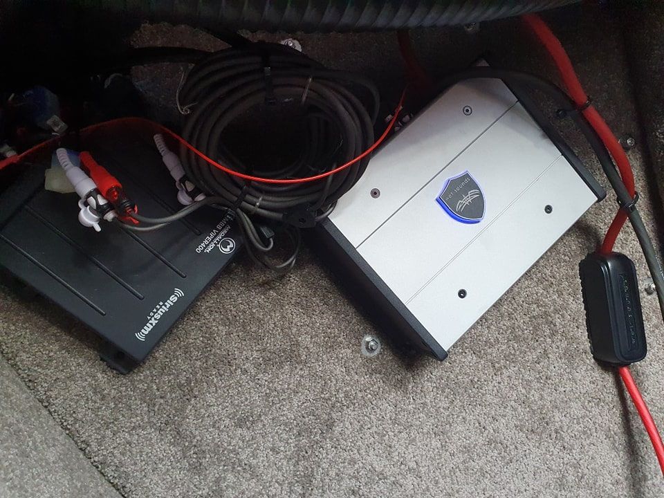 An Amplifier is Sitting on a Carpet Next to Some Wires — OSP Automotive & Marine In Grafton, NSW