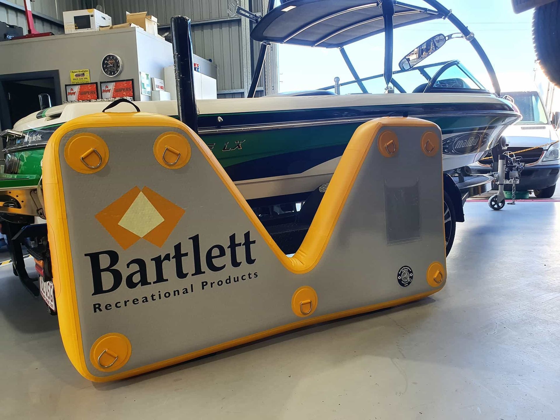 A Boat is Being Towed by a Bartlett Inflatable Platform — OSP Automotive & Marine In Grafton, NSW