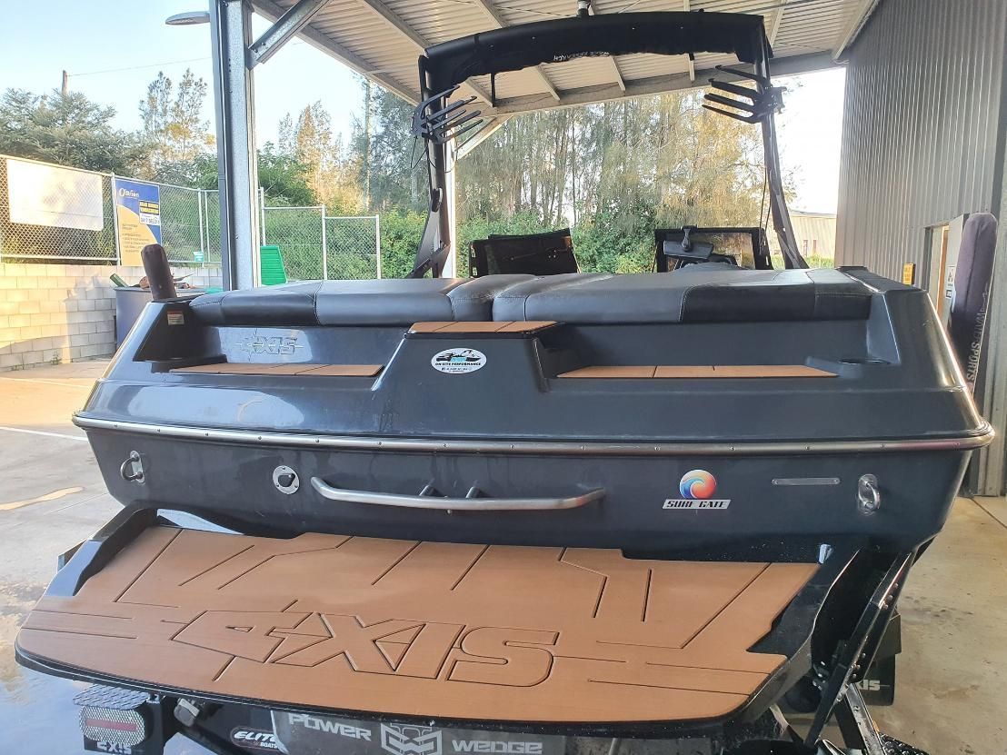 A Black Boat is Parked Under a Roof in a Garage — OSP Automotive & Marine In Grafton, NSW