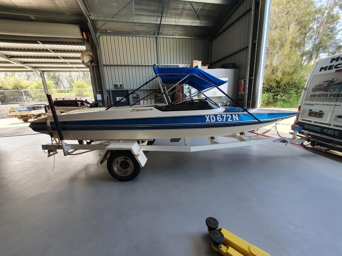 A Blue and White Boat is Parked in a Garage — OSP Automotive & Marine In Grafton, NSW
