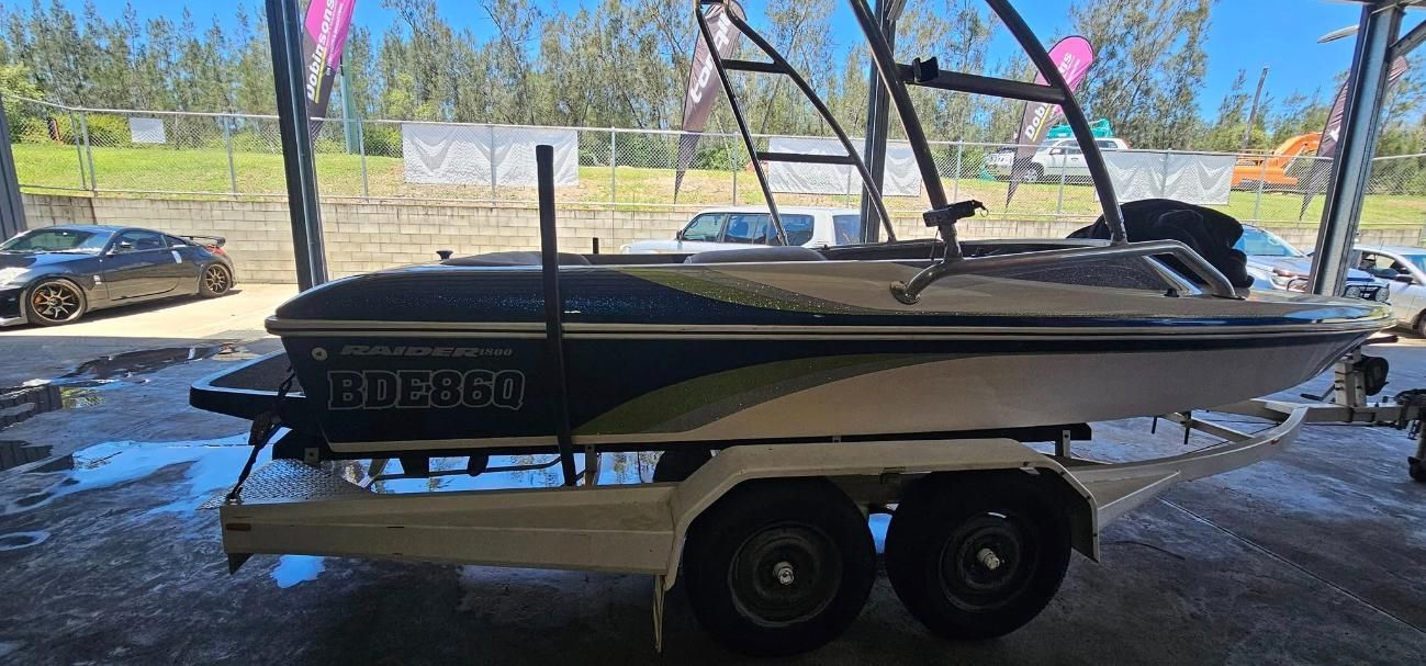 A Boat is Sitting on a Trailer in a Parking Lot — OSP Automotive & Marine In Woolgoola, NSW