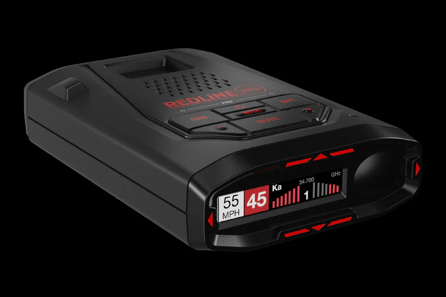 Black handheld radar detector with red digital display and indicator lights