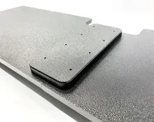 Black metal mounting bracket with tabs and cutouts on a white background