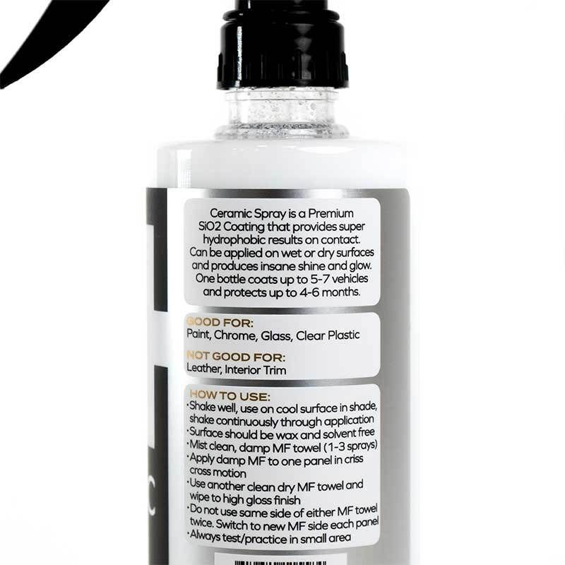 Ceramic spray bottle with black trigger nozzle and gray label on a white background