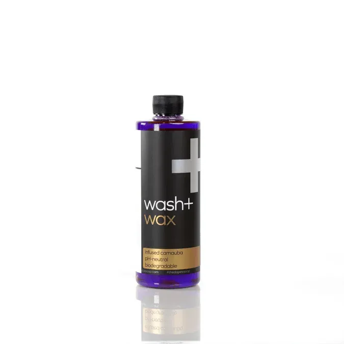 Black wash+ WAX bottle with purple cap on a white background