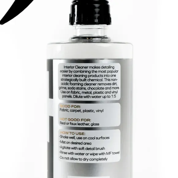 Black spray bottle labeled “interior cleaner” on a white background