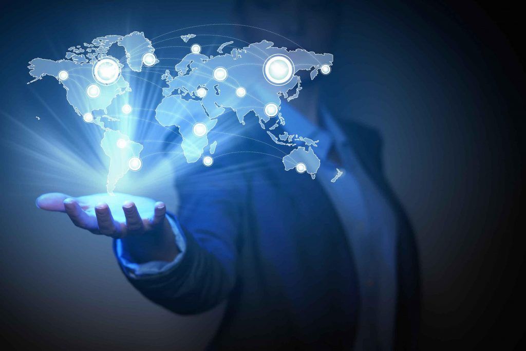 Person holding glowing world map with connected dots. Blue light emanates from hand.