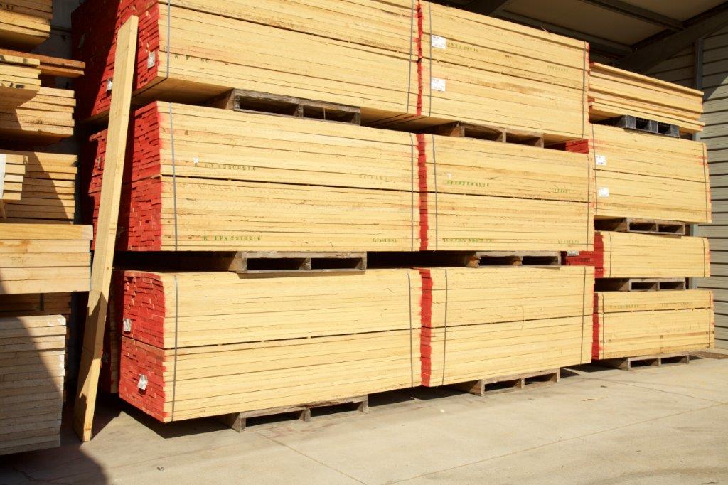 Una pila di pallet di legno appoggiati uno sopra l'altro sul terreno.