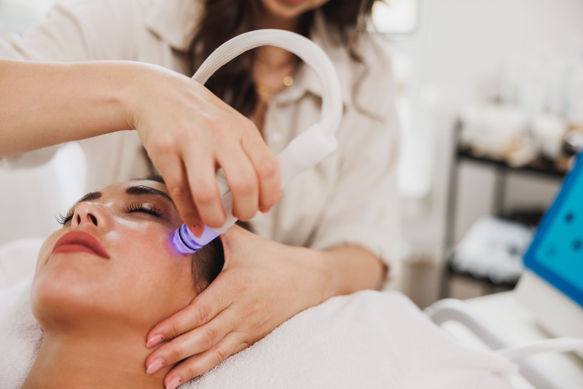 A woman is getting a facial treatment at a beauty salon.