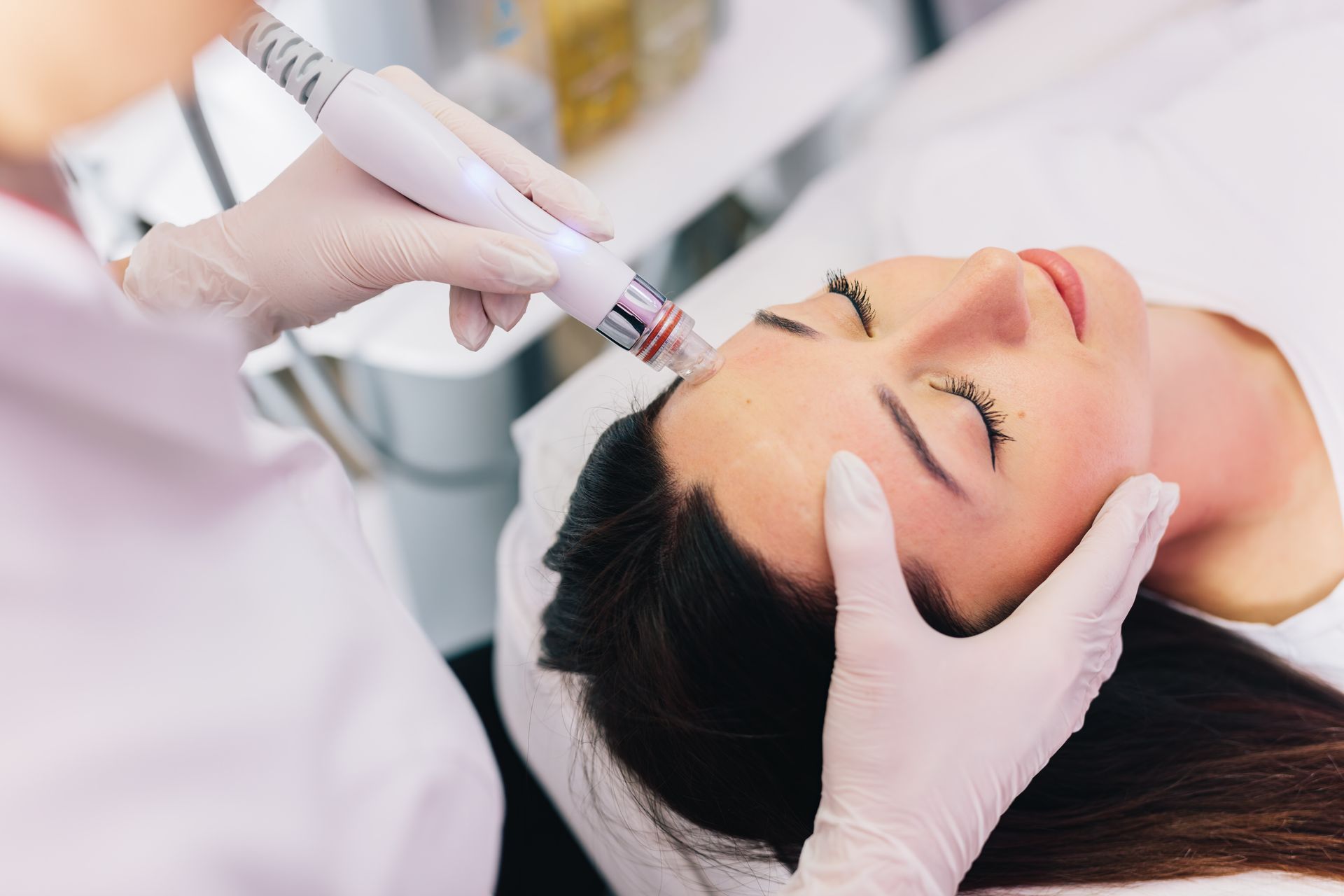 A woman is getting a facial treatment at a beauty salon.