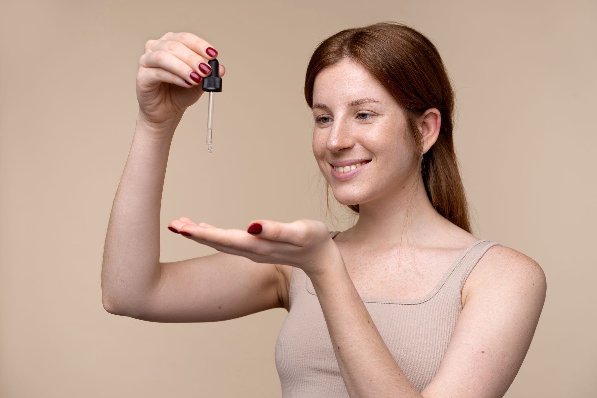 A woman is holding a pipette in her hand.