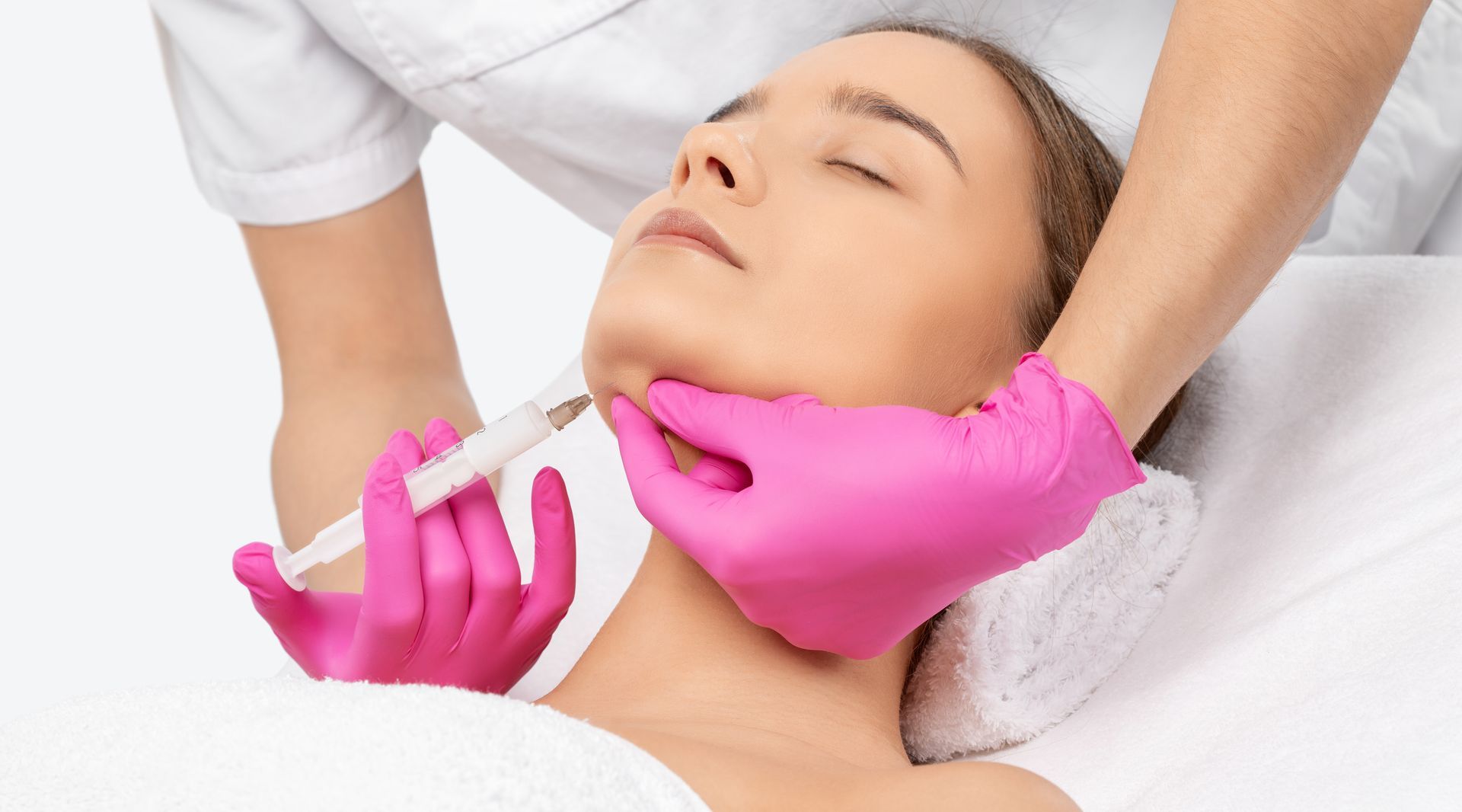 A woman is getting a botox injection in her neck.