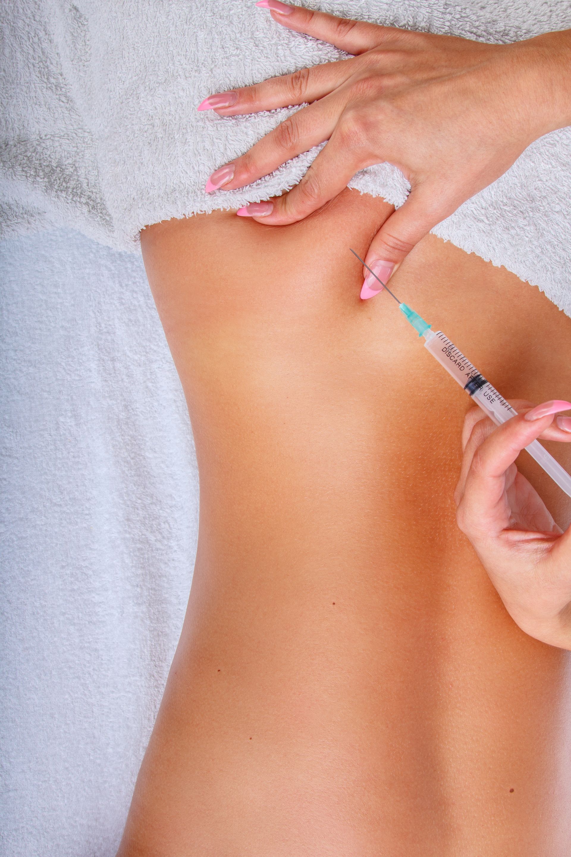 A woman is getting an injection in her back.