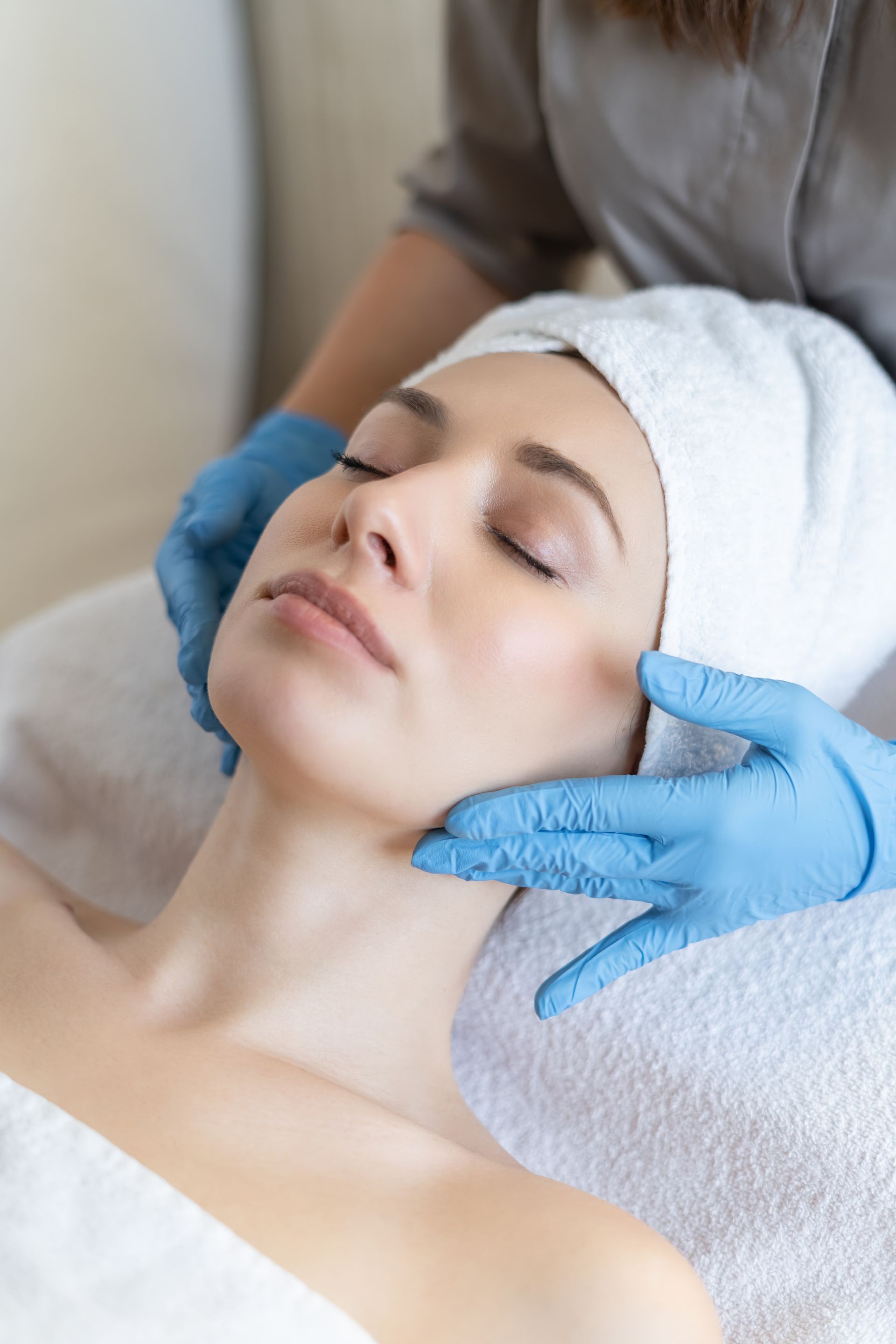 A woman is getting a facial treatment at a spa.