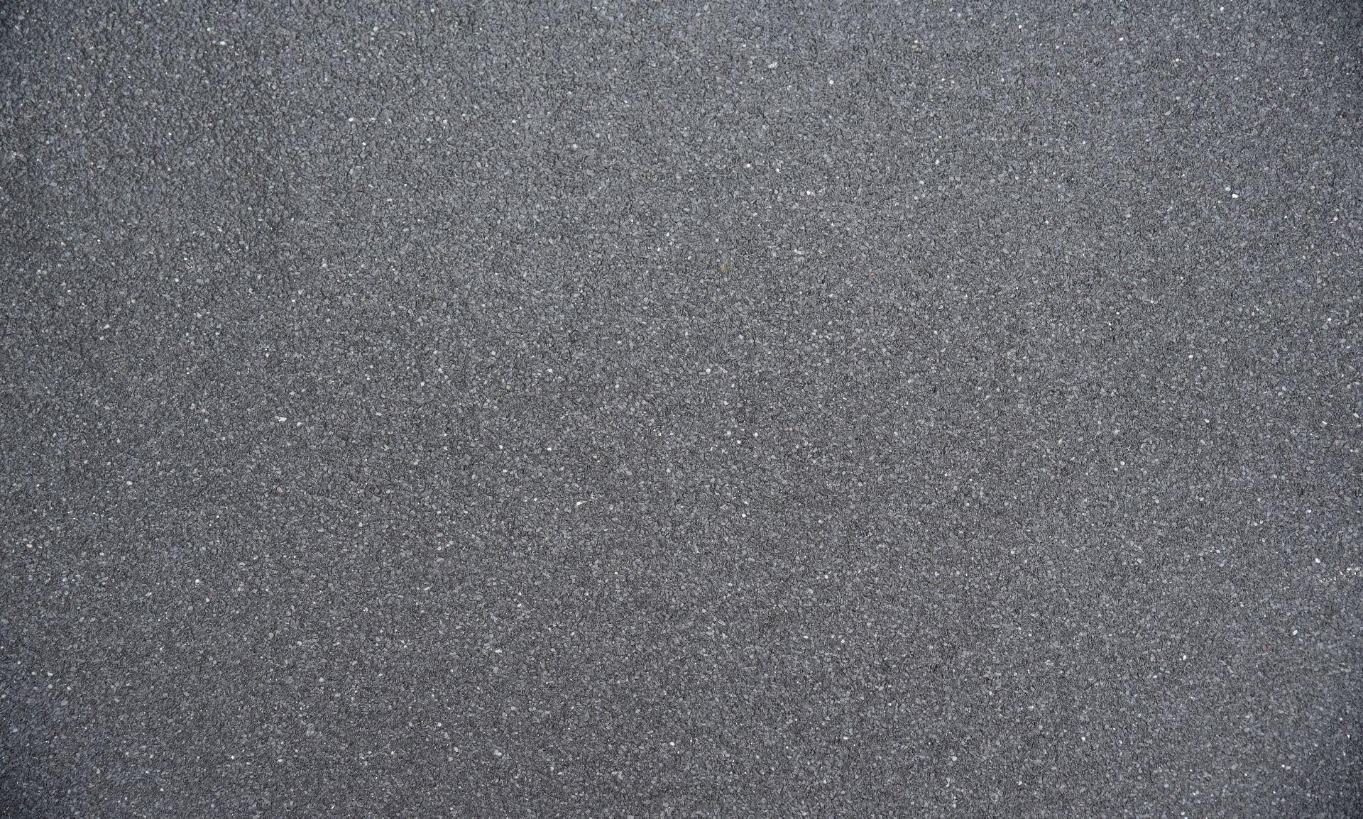 Gray speckled textured surface with a subtle grainy pattern