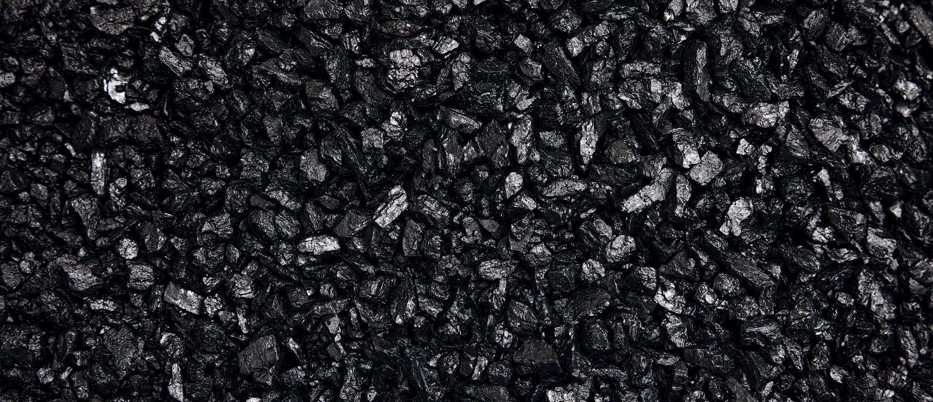 Close-up of dark black gravel or crushed stone texture
