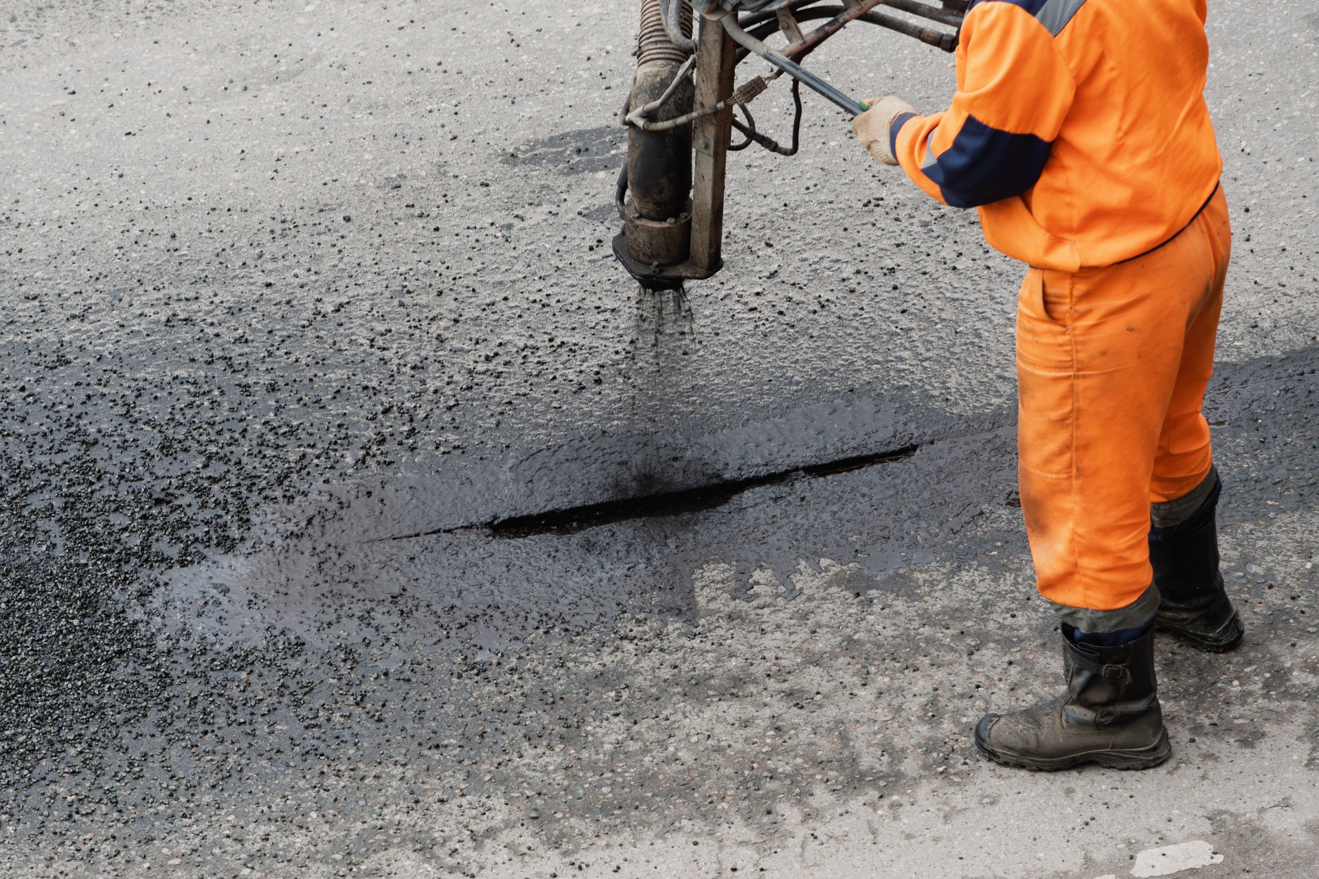 Cracked and degraded commercial asphalt parking lot surface in Battle Creek, Michigan showing freeze-thaw damage