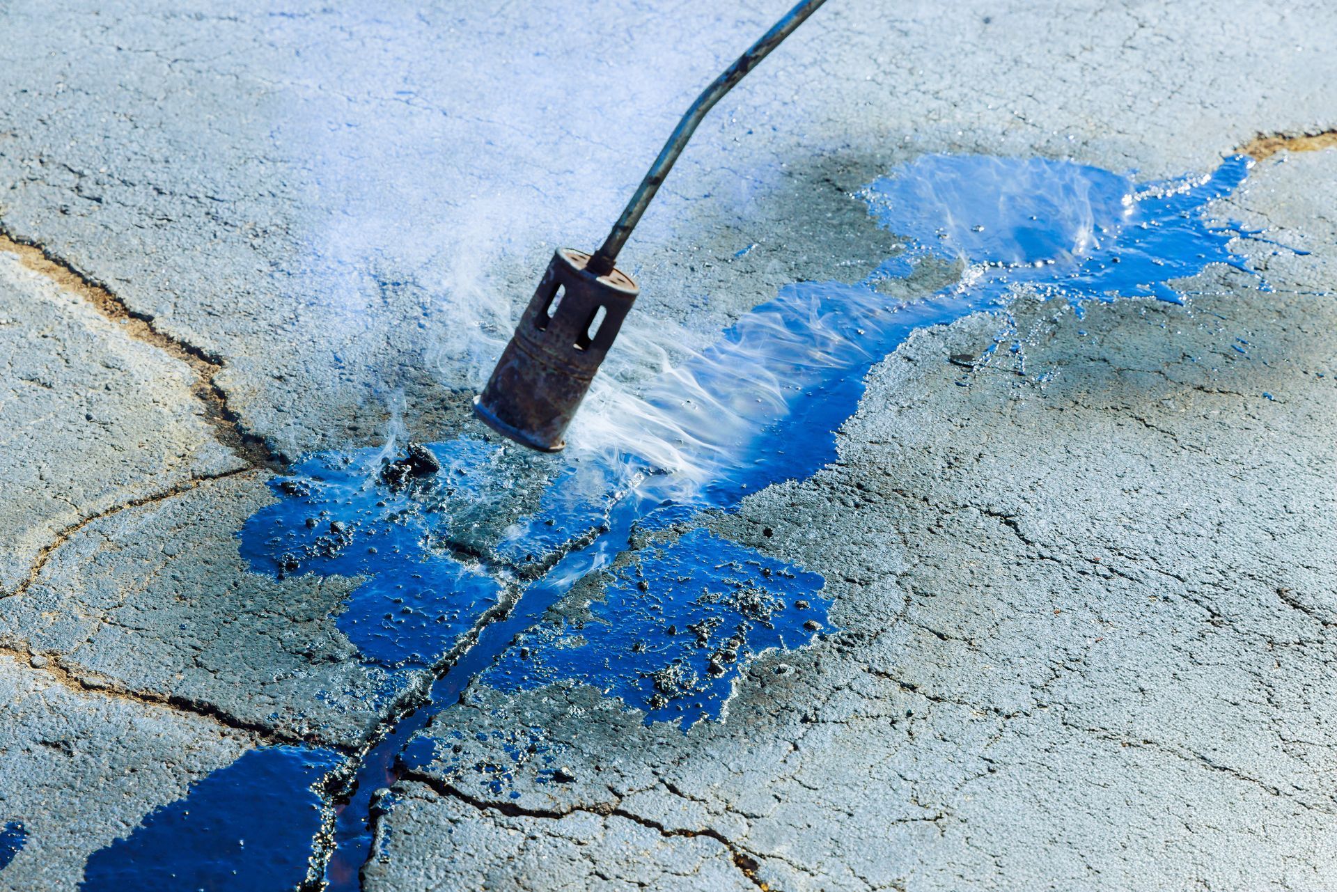 Edge spalling along driveway apron before repair