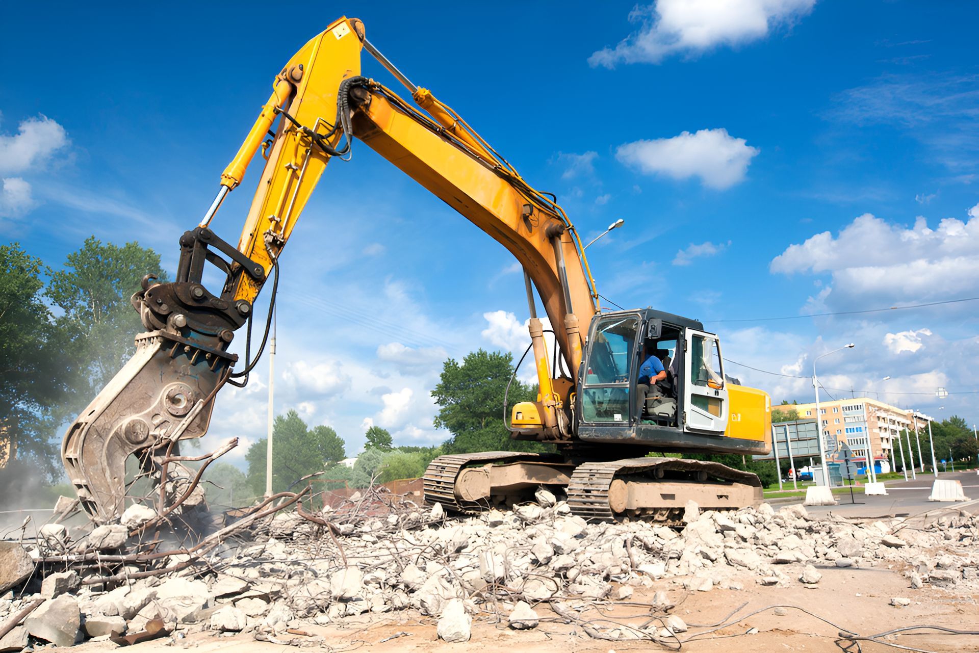 A Large Yellow Excavator Is Demolishing A Building — ACC Excavations & Demolition Pty Ltd In Wollongong, NSW