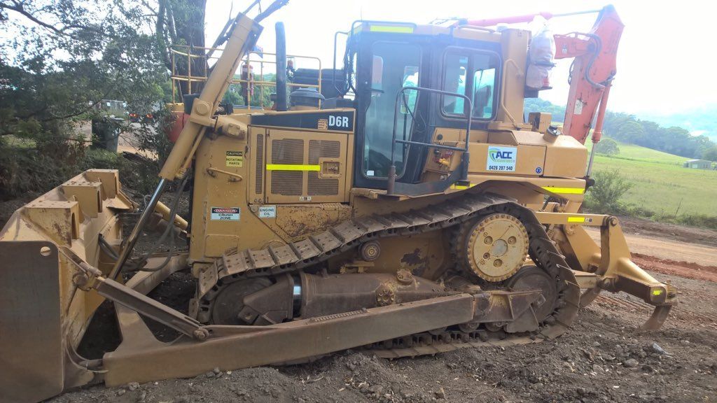 A Bulldozer Is Parked On The Side Of A Dirt Road — ACC Excavations & Demolition Pty Ltd In Albion Park, NSW