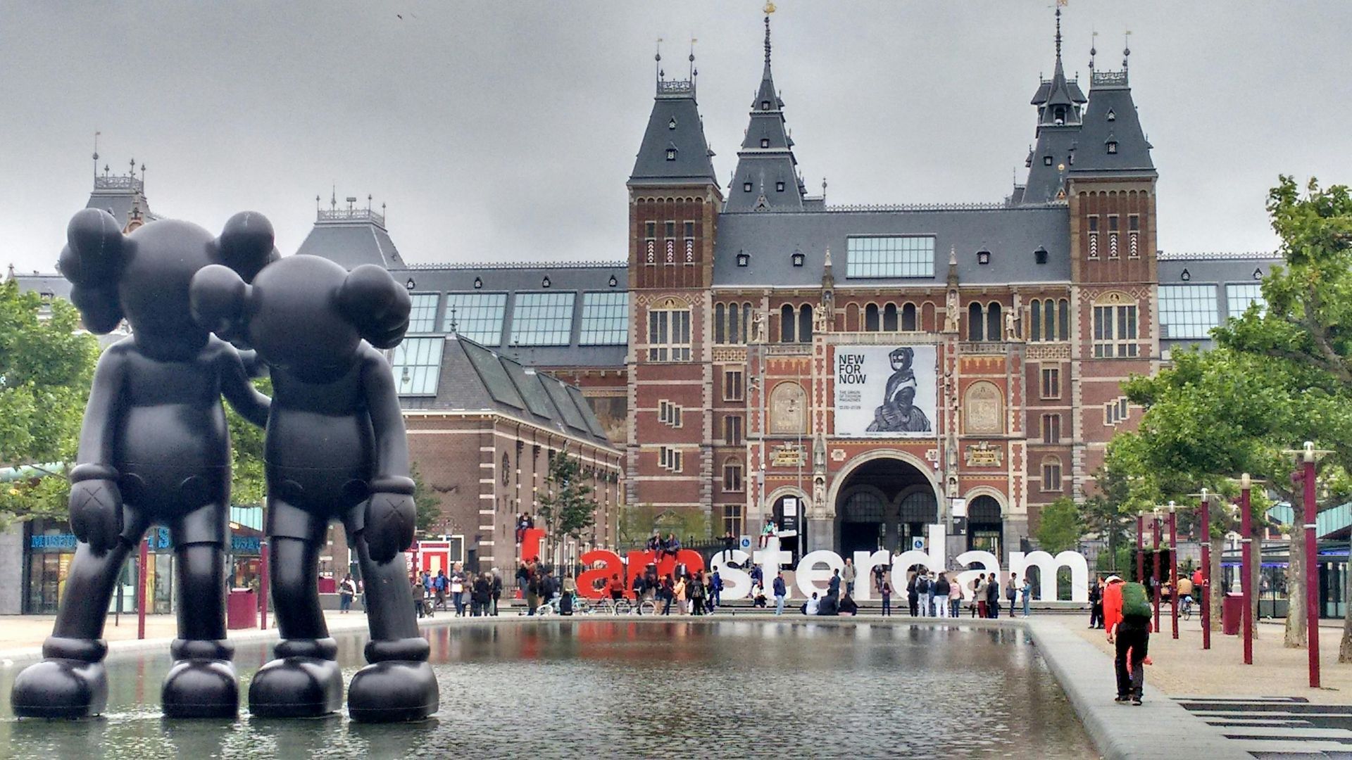 Two KAWS figures stand in front of the Rijksmuseum in Amsterdam with 