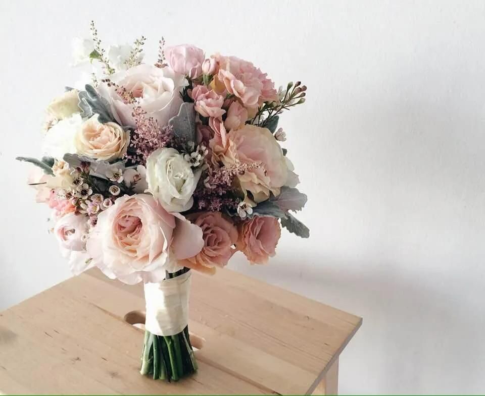 A Bouquet of Flowers is Sitting on a Wooden Stool — Flower Hunt in Robina, QLD