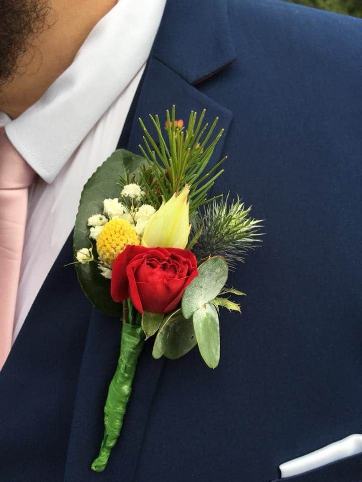 A Man Wearing a Blue Suit and a Pink Tie Has a Buttonhole With Flowers on His Jacket — Flower Hunt in Robina, QLD