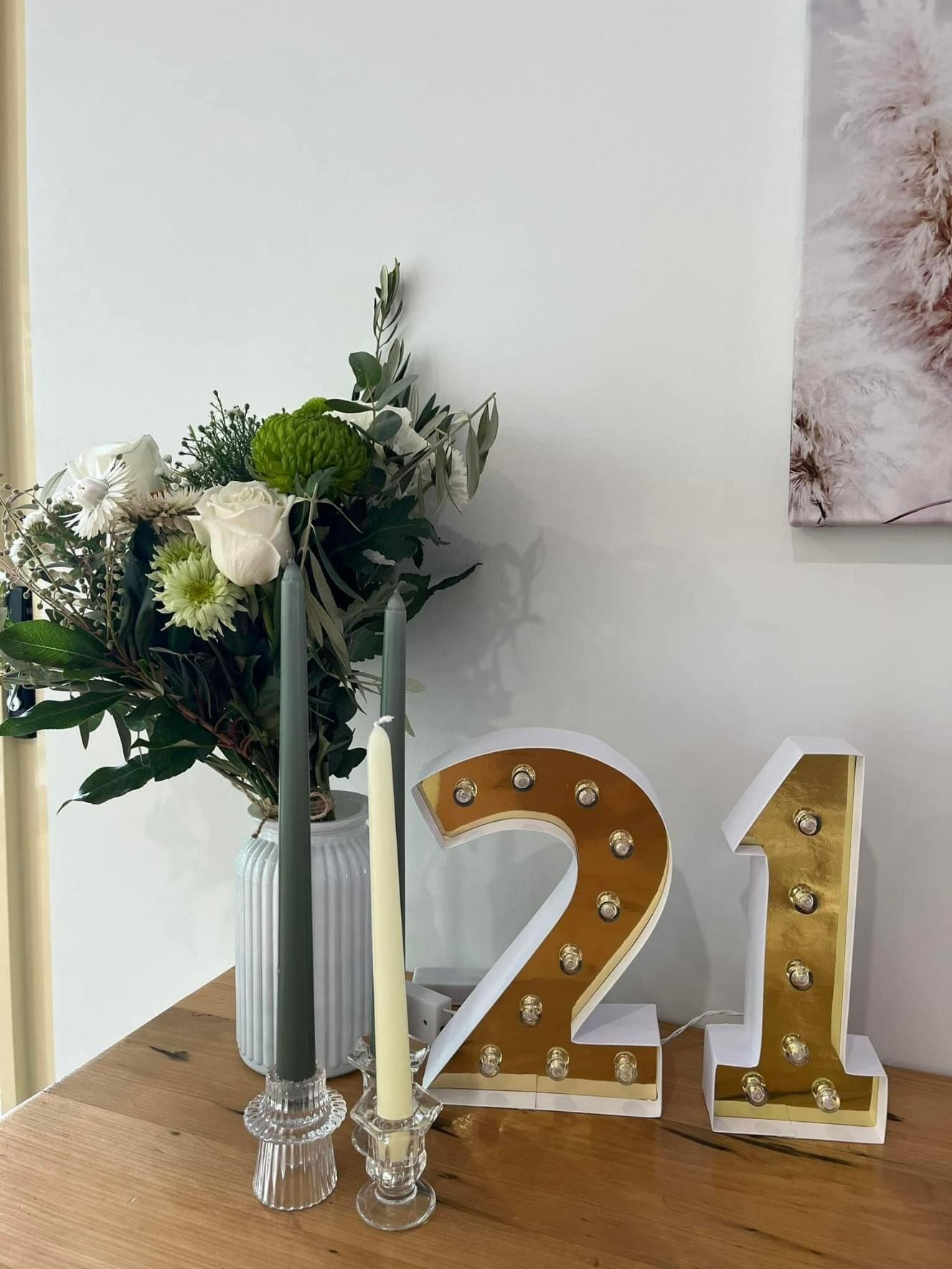 A Table With a Vase of Flowers and Candles and the Number 21 on It — Flower Hunt in Robina, QLD