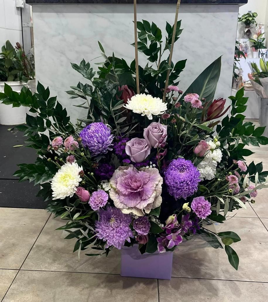 A Bouquet of Purple and White Flowers in a Purple Vase — Flower Hunt in Robina, QLD
