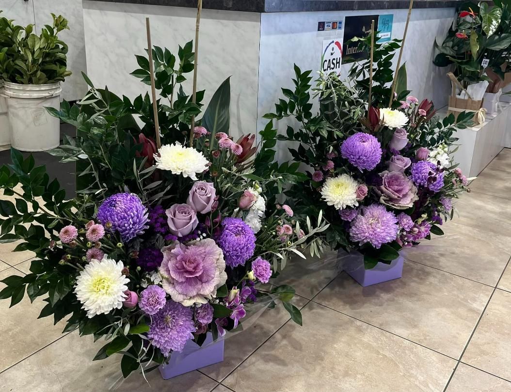 Two Vases Filled With Purple and White Flowers Are Sitting on a Tiled Floor — Flower Hunt in Robina, QLD