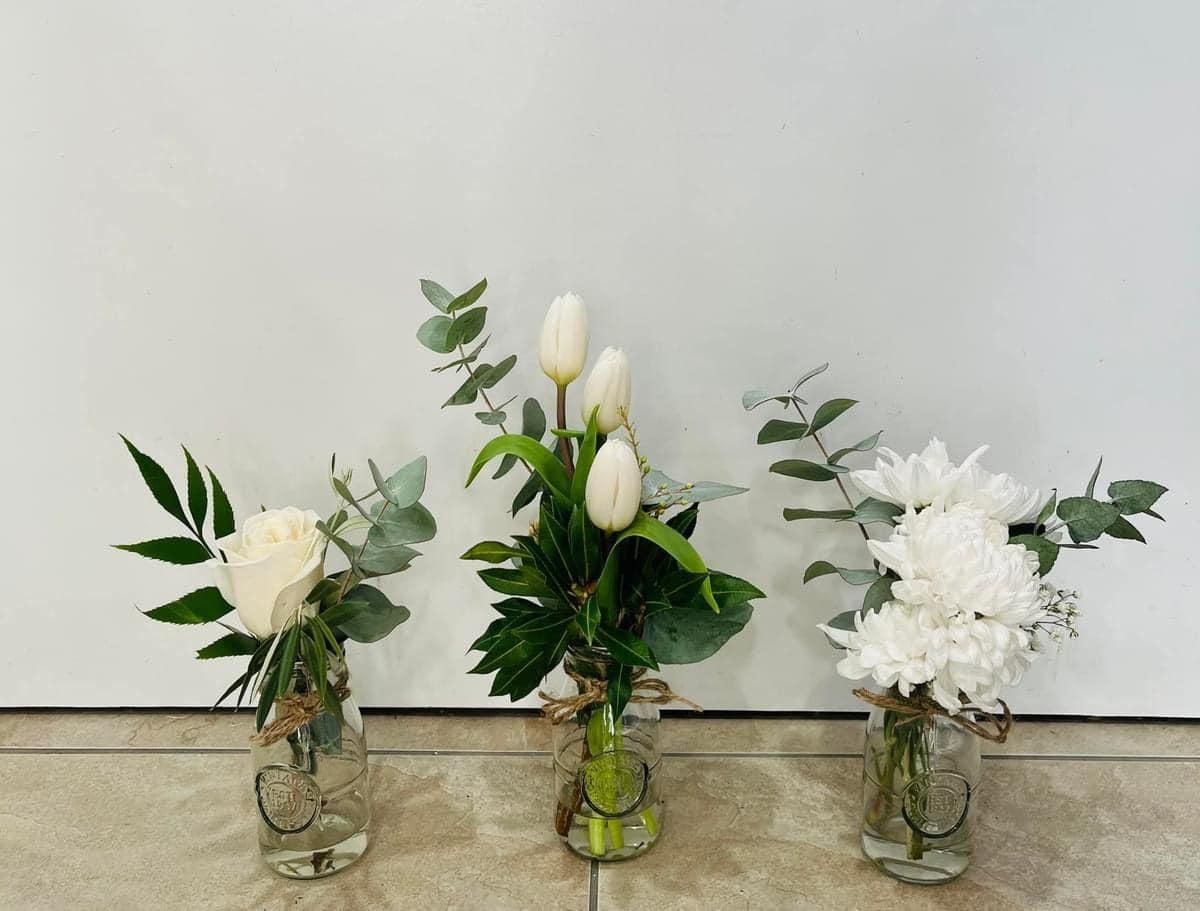 Three Vases Filled With White Flowers Are Sitting on a Tiled Floor — Flower Hunt in Robina, QLD