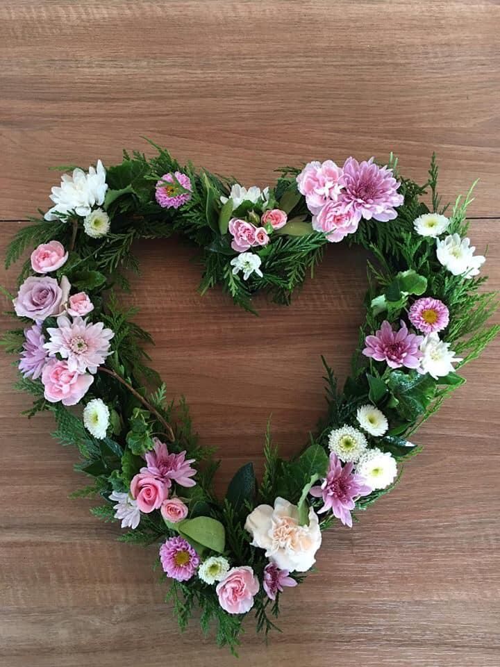 A Heart Shaped Wreath of Pink and White Flowers on a Wooden Table — Flower Hunt in Robina, QLD