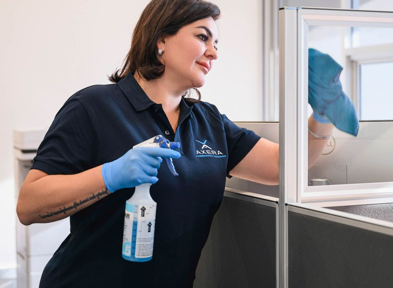 Professional cleaner maintaining an office workspace
