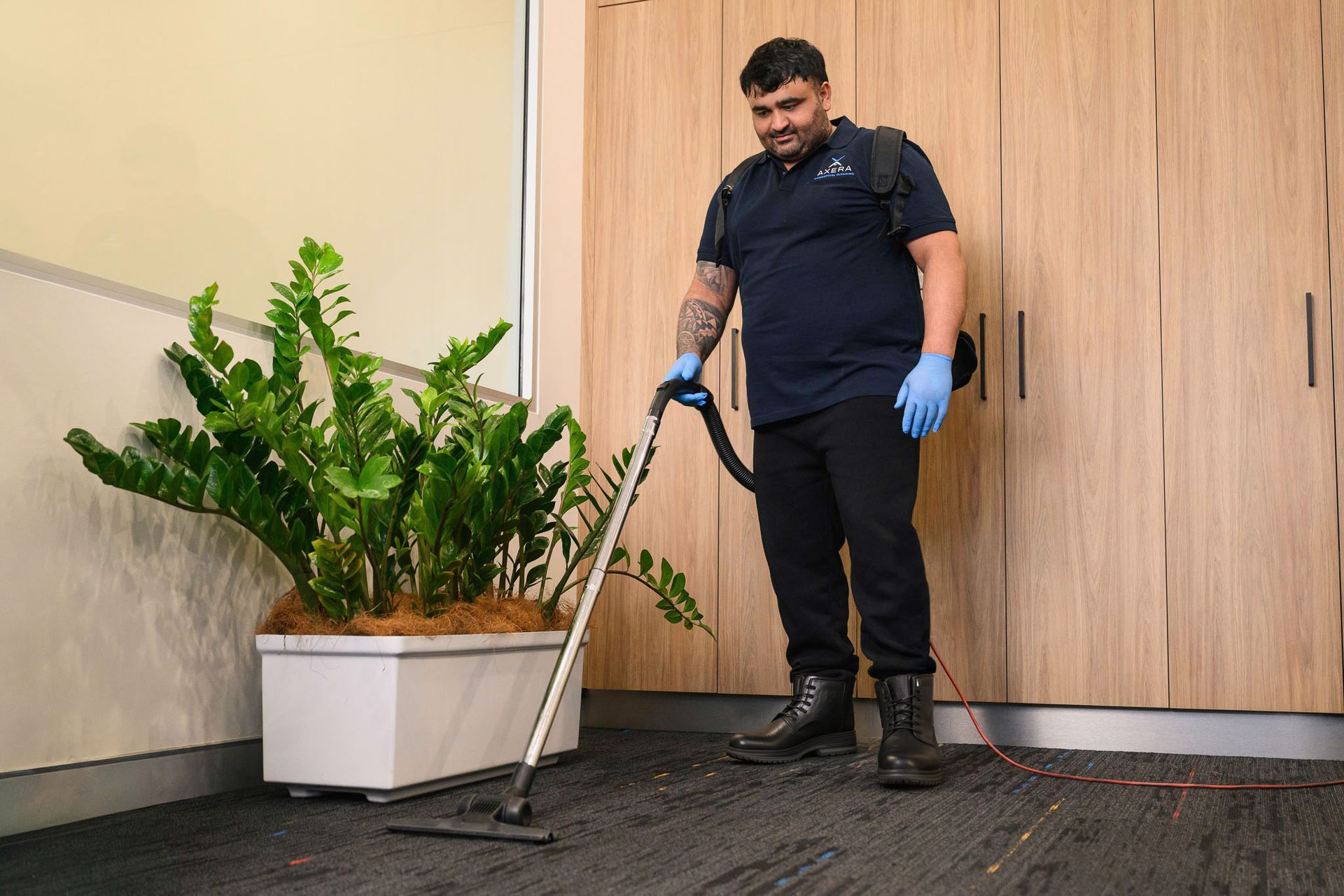 Commercial cleaner vacuuming carpet in an office