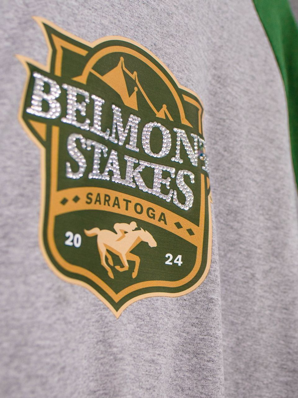 A belmont stakes logo is on a grey shirt