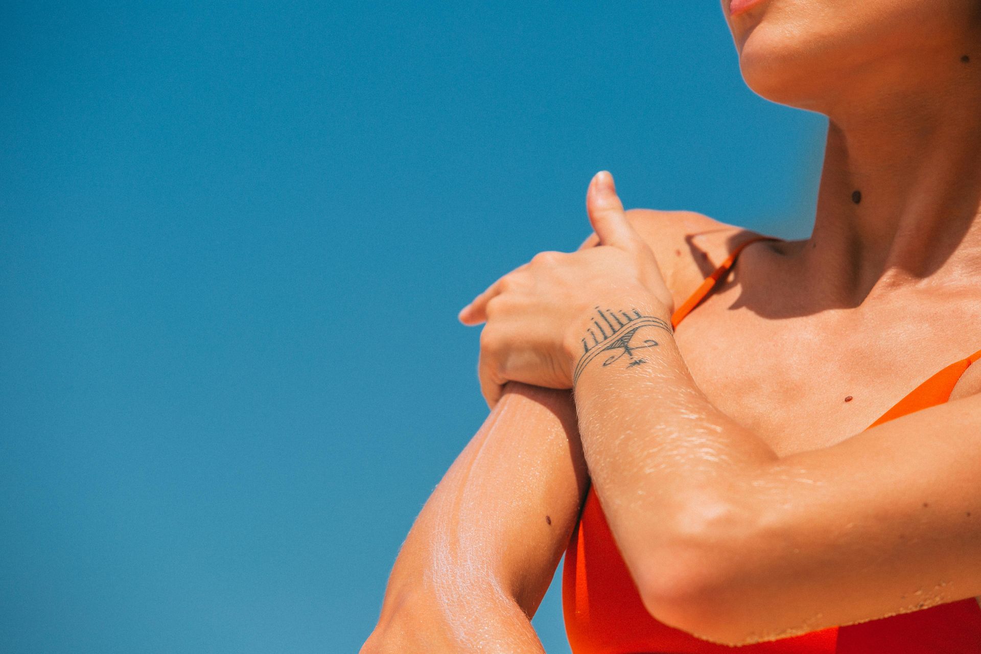 Person applying sunscreen outdoors in Myrtle Beach SC.