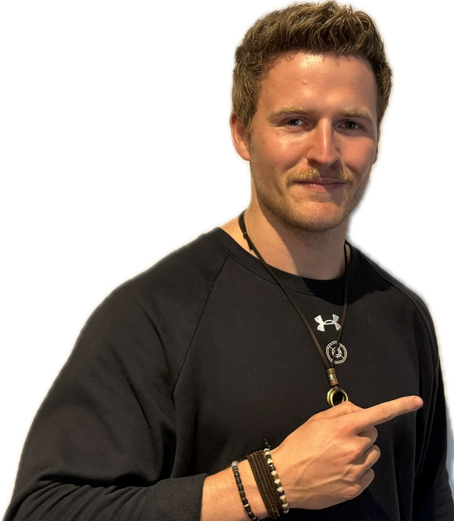 Man in white and black athletic shirt pointing right, smiling. 