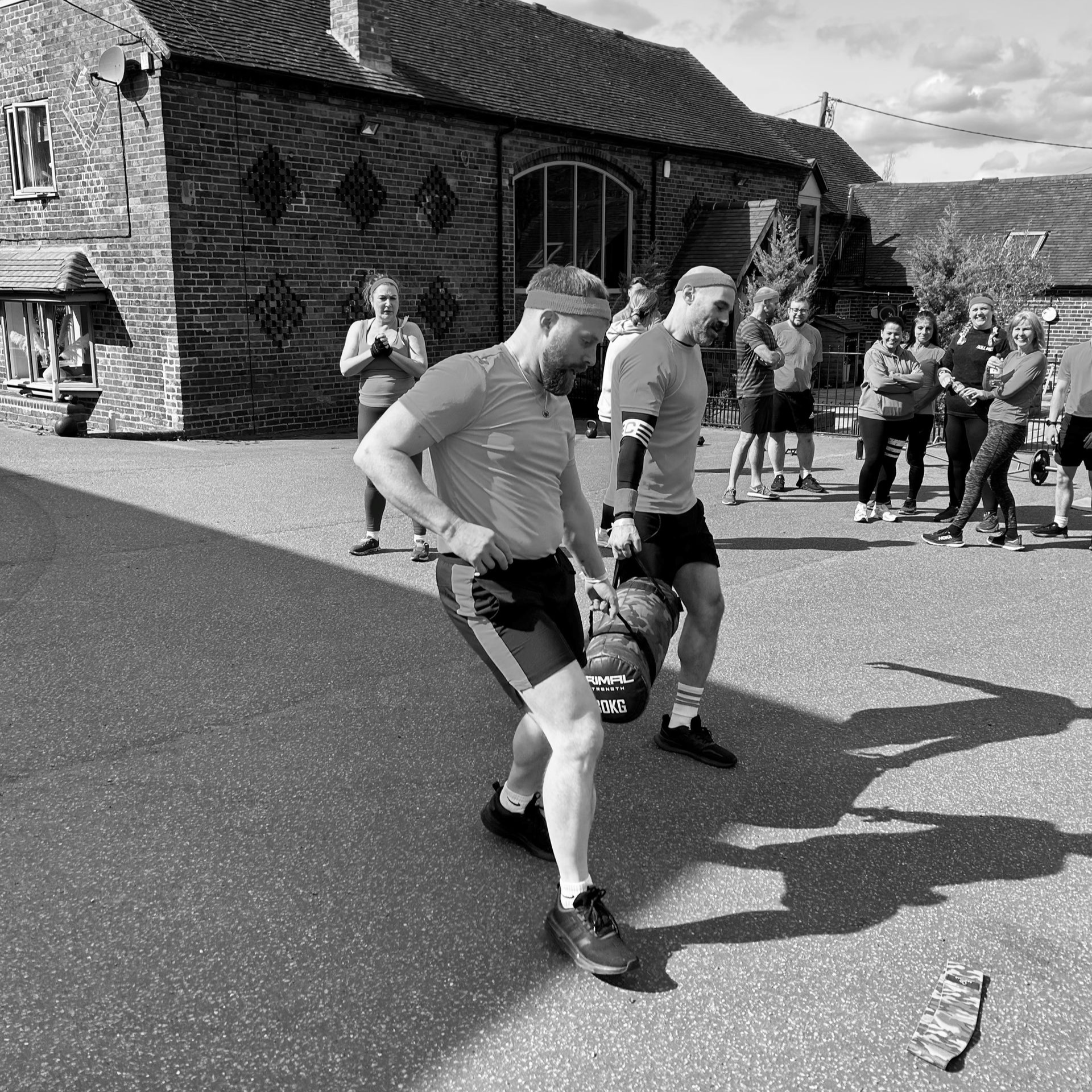 Children running in a race outside a stone building on a sunny day