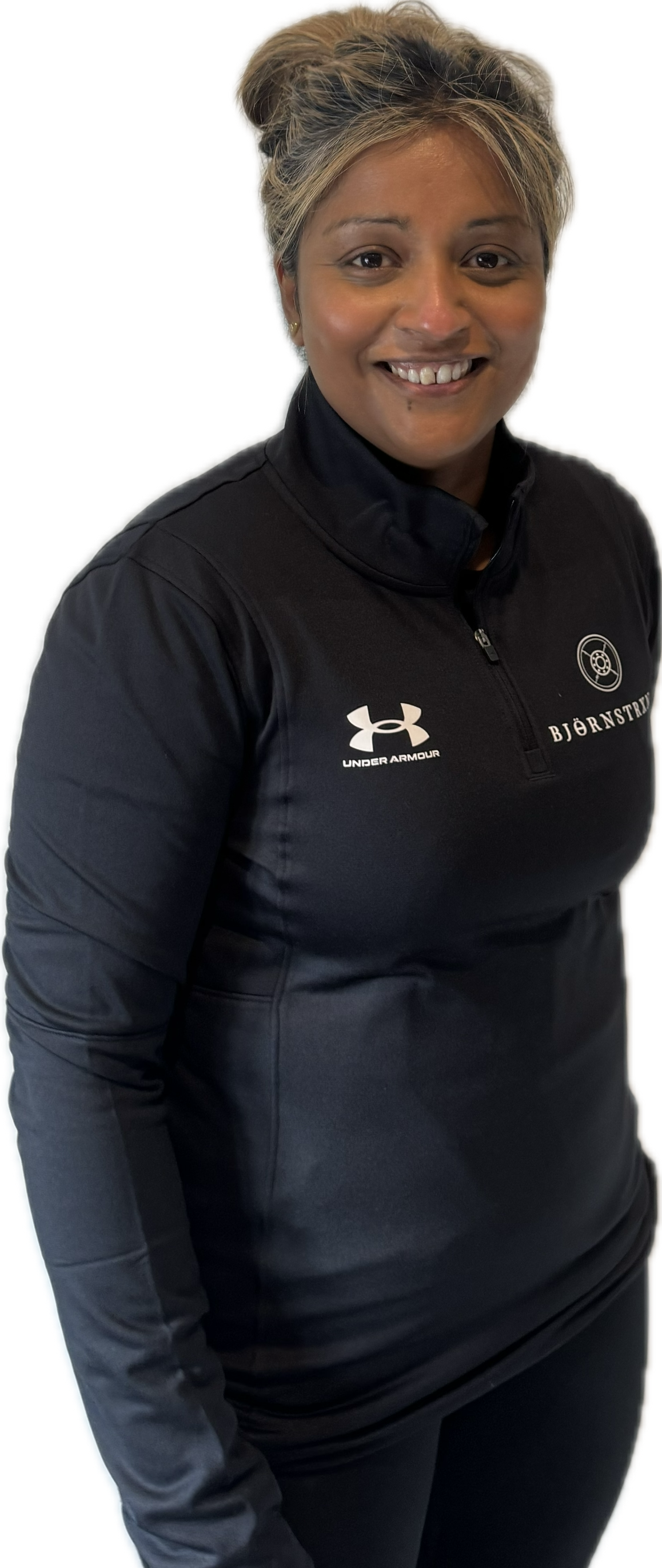 Man in white and black athletic shirt with a logo, standing and smiling.