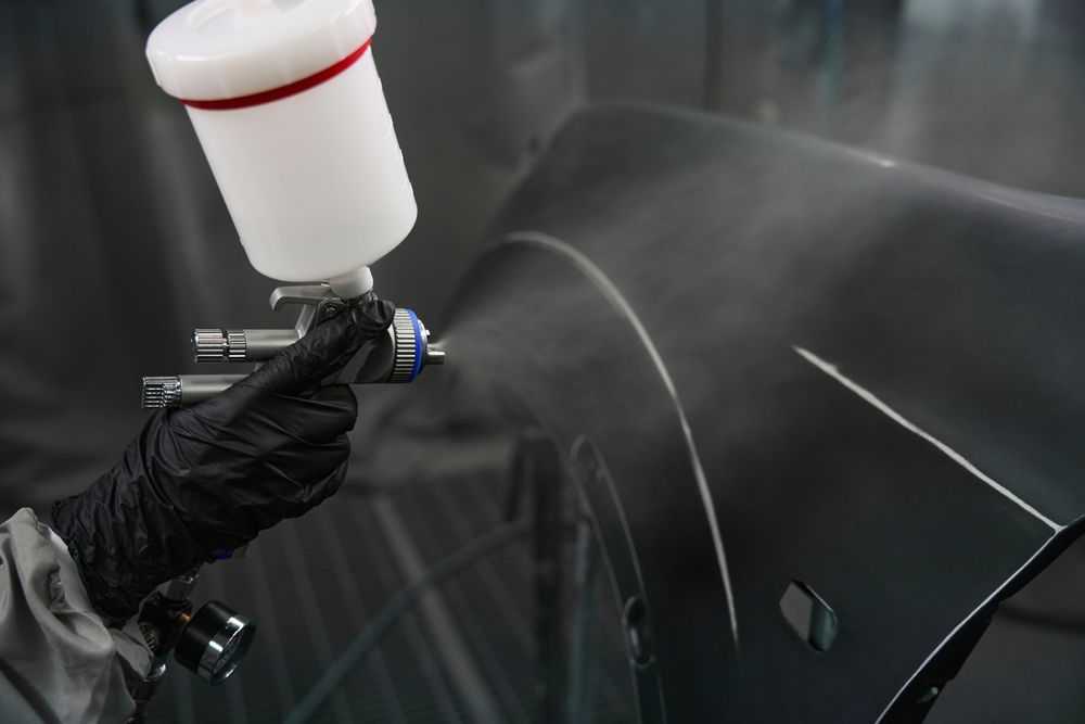 Worker Painting Car Body Indoors — Panel Beater in Griffith, NSW