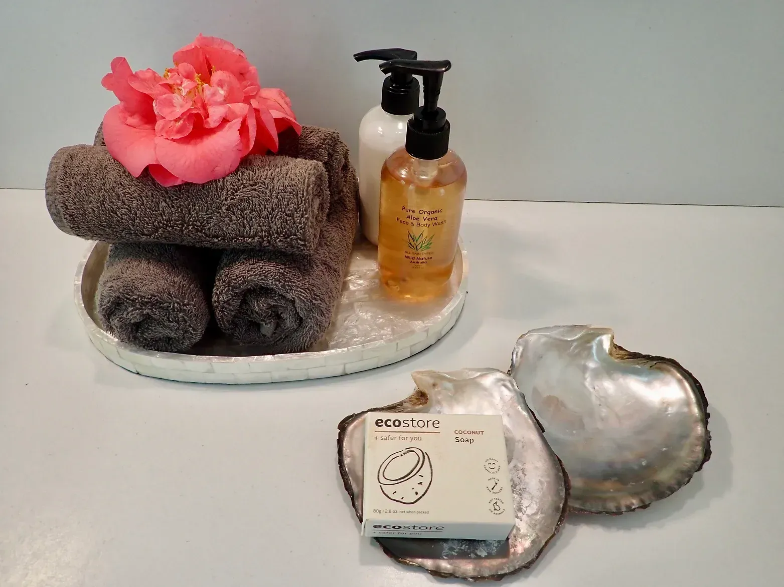 Spa gift set with towel, flower, lotion, soap, and heart-shaped dish on a tray