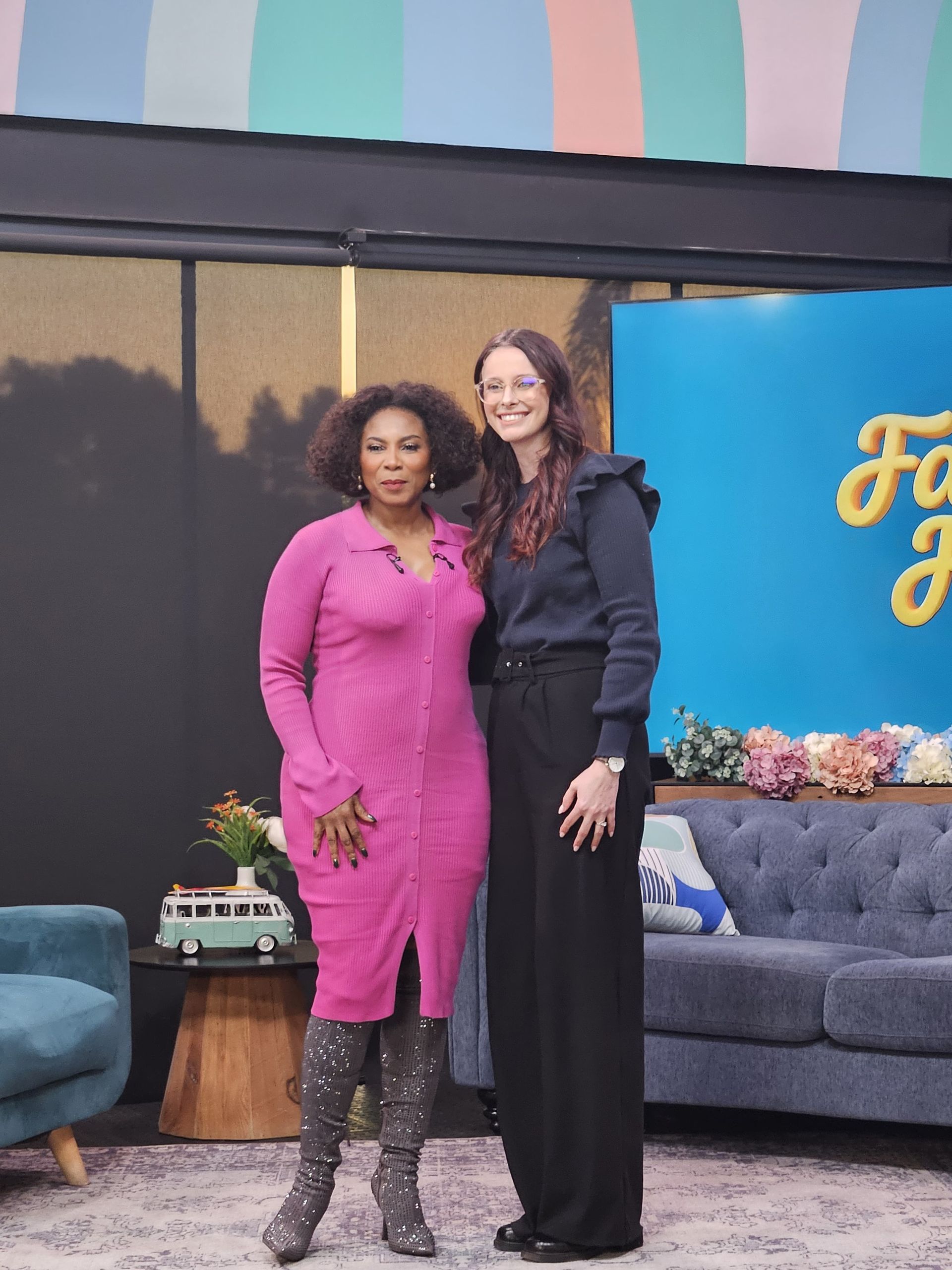 Nikki Russell and Penny Lebyane standing on a studio set SABC Eintlek Let's Connect