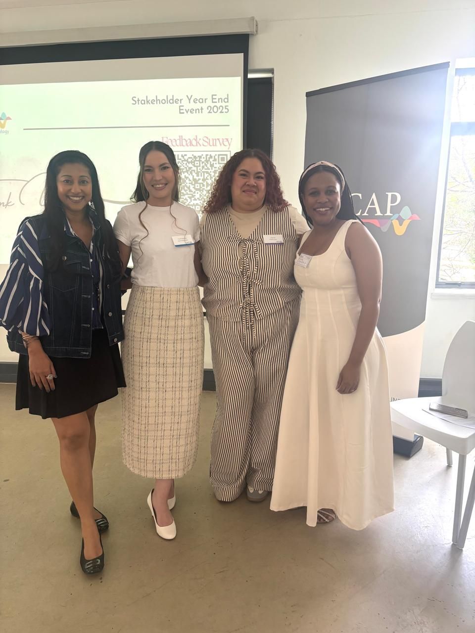 Four people at SACAP stand smiling side-by-side.