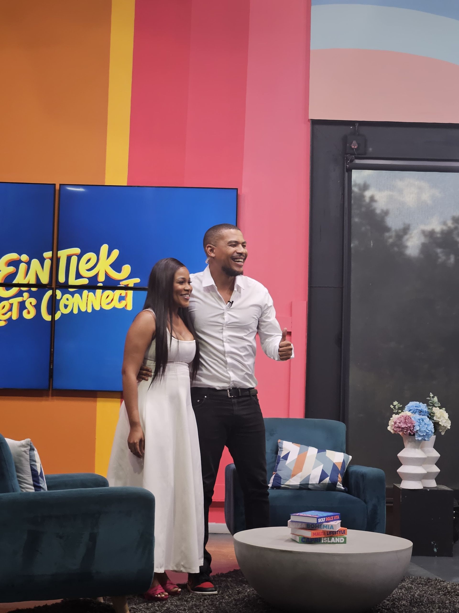 Zinzisa and Fran-Rico Lucas smiling  and stands together on a television studio at 