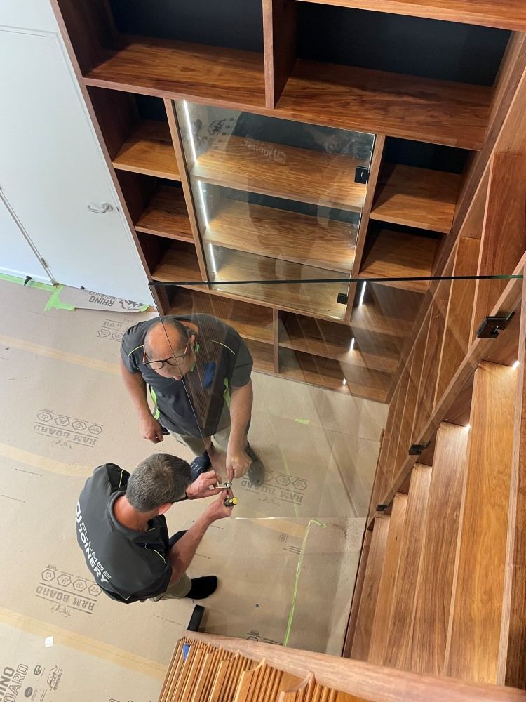 A Couple Of Men Are Standing Next To Each Other In A Room — Plumbe Joinery in Coffs Harbour, NSW