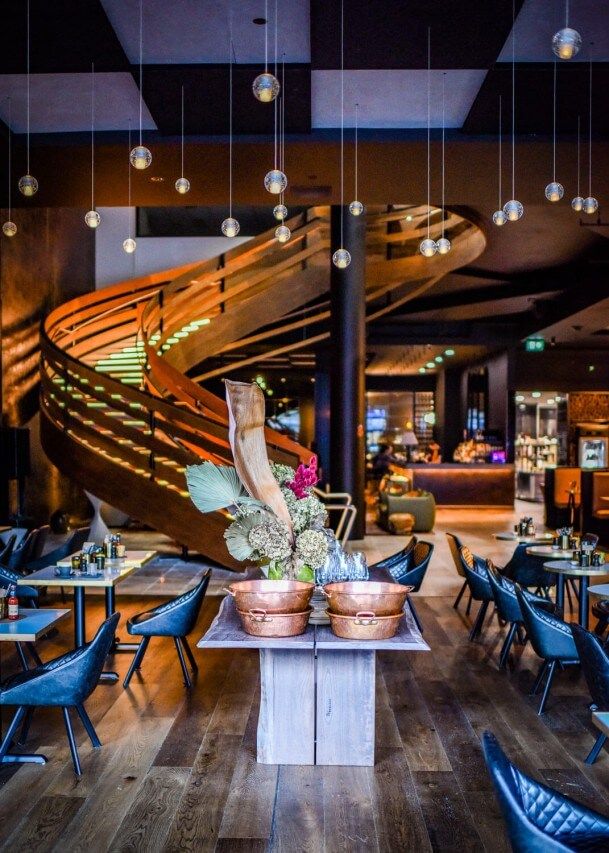 A Hotel Restaurant With A Large Spiral Wooden Staircase — Plumbe Joinery in Coffs Harbour, NSW