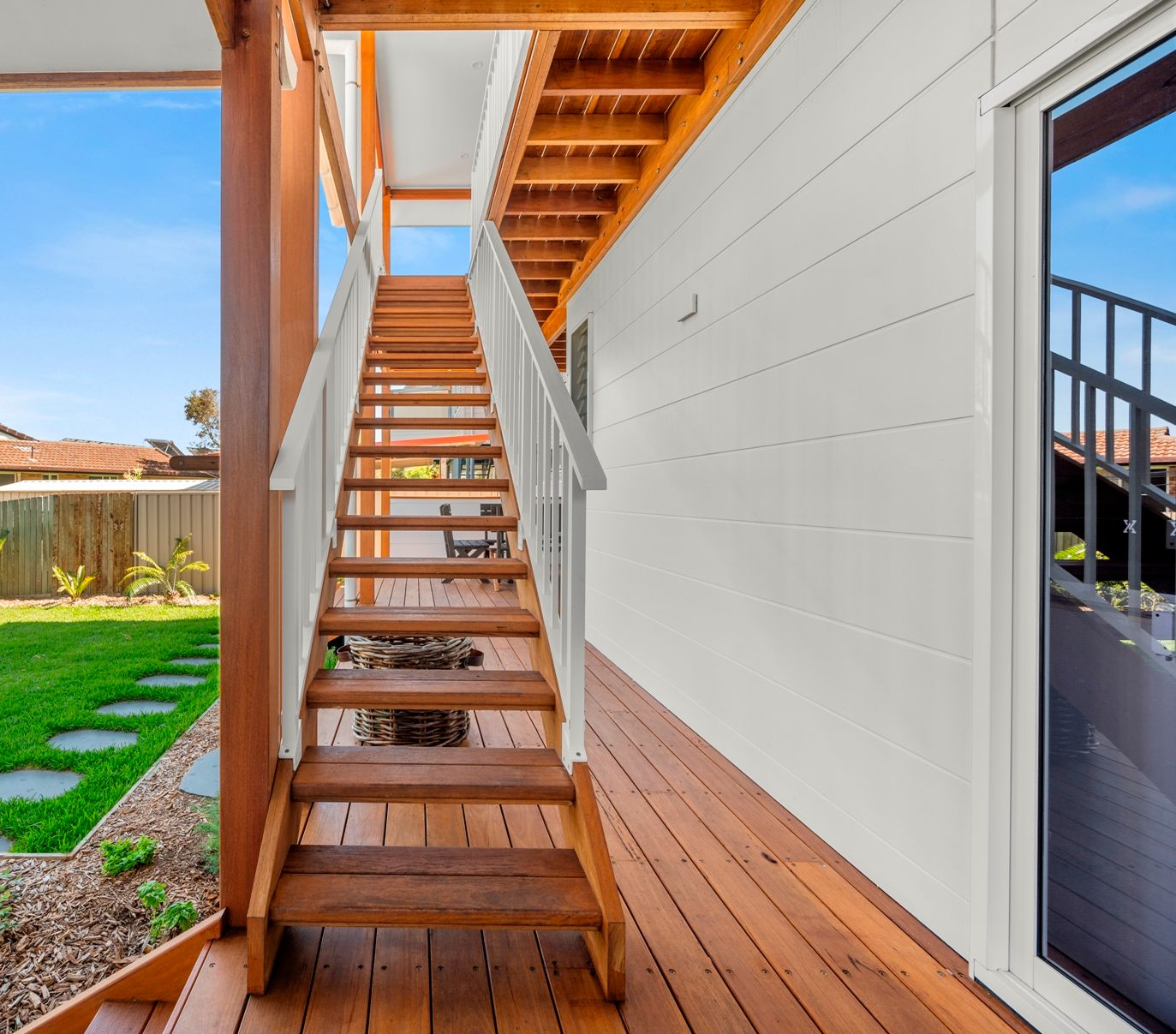 A Wooden Deck With Stairs Leading Up to the Second Floor of a House — Plumbe Joinery in Coffs Harbour, NSW