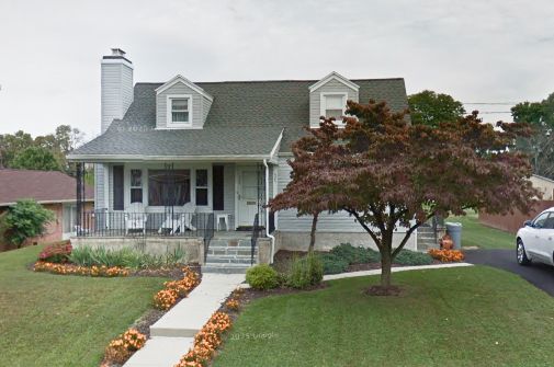 A house with a car parked in front of it